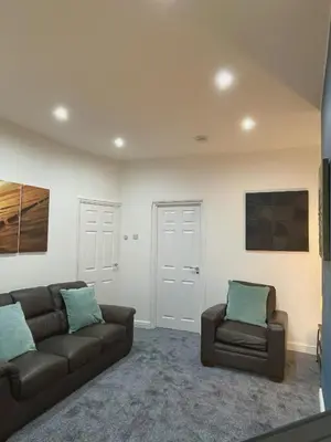 a living room with a couch and a chair at Ideal 3 bed pay-as-you-stay home in Wigan sleeps 6 in Wigan