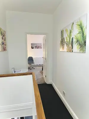 an empty room with a desk and a hallway at Ideal 3 bed pay-as-you-stay home in Wigan sleeps 6 in Wigan