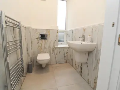 a bathroom with a sink and a toilet and a window at 163 Manchester Road in Accrington