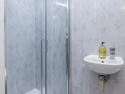 a bathroom with a shower and a sink at 163 Manchester Road in Accrington
