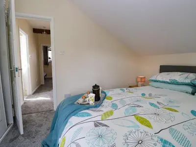 a bedroom with a bed with two stuffed animals on it at The Old Surgery in Grange Over Sands