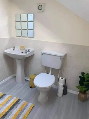 a bathroom with a toilet and a sink at The Old Surgery in Grange Over Sands