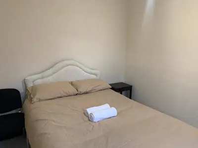 a bed with a white box on top of it at Queens Hotel in Blackburn