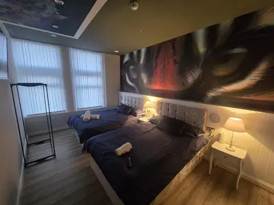 two beds in a room with a painting on the wall at Liverpool city center Apartments Dawson Street in Liverpool