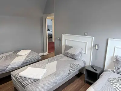 a room with two beds and a mirror at Twelfth Man Accommodation part of The Twelfth Man Public House in Liverpool
