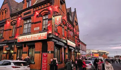 a group of people standing outside of a building at Twelfth Man Accommodation part of The Twelfth Man Public House in Liverpool