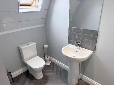 a small bathroom with a toilet and a sink at Twelfth Man Accommodation part of The Twelfth Man Public House in Liverpool