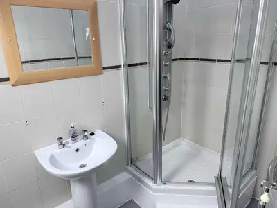 a bathroom with a shower and a sink at Twelfth Man Accommodation part of The Twelfth Man Public House in Liverpool