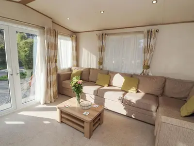 a living room with a couch and a table at Lodge 1 in Carnforth