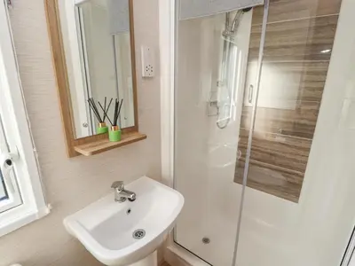a bathroom with a sink and a shower at Lodge 1 in Carnforth