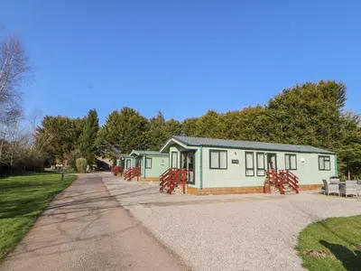 a building with a playground in the park at Lodge 1 in Carnforth