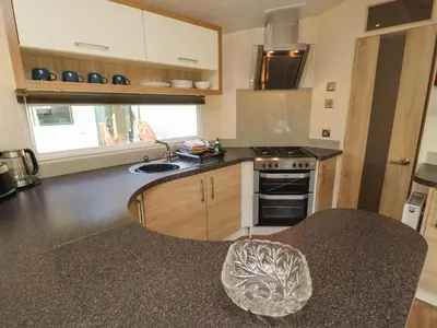 a kitchen with a sink and a stove top oven at Lodge 3 in Carnforth