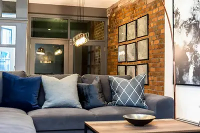 a living room with a couch and a brick wall at Bands Warehouse I in Liverpool