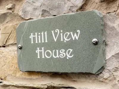 a sign that reads hill view house on a stone wall at Lovely 2 Bed With Pool Table Ulverston - Pass the Keys in Ulverston