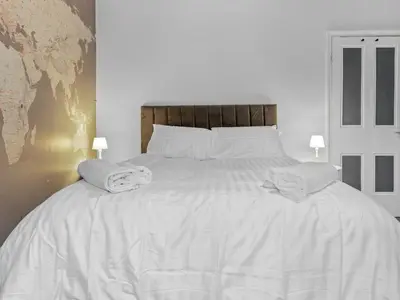 a bedroom with a white bed with towels on it at Lovely 2 Bed With Pool Table Ulverston - Pass the Keys in Ulverston