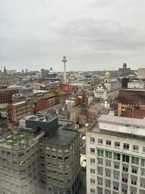 a view of a city with a water tower in the distance at Two Bedroom City View Apartment Liverpool by StaySavvy Accommodation in Liverpool
