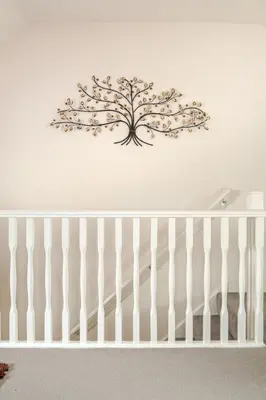 a metal tree on the wall above a crib at Town house Anfield stadium in Liverpool