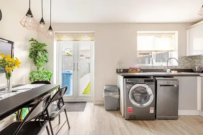 a kitchen with a washing machine in a kitchen at Town house Anfield stadium in Liverpool