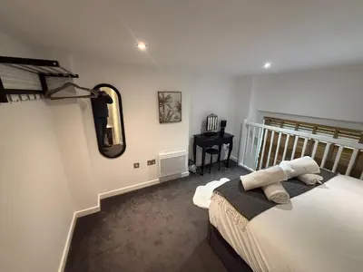 a bedroom with a bed and a mirror and a desk at 5 Halifax House Apartment 7 in Liverpool
