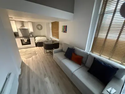 a living room with a couch and a dining room at 5 Halifax House Apartment 7 in Liverpool