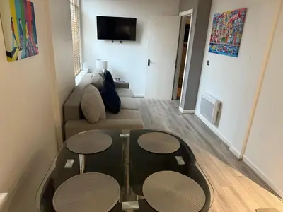 a living room with a couch and two tables at 5 Halifax House Apartment 7 in Liverpool