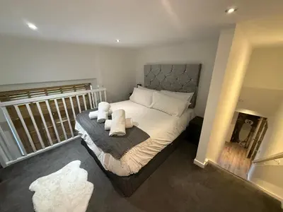 a bedroom with a bed with towels on it at 5 Halifax House Apartment 7 in Liverpool