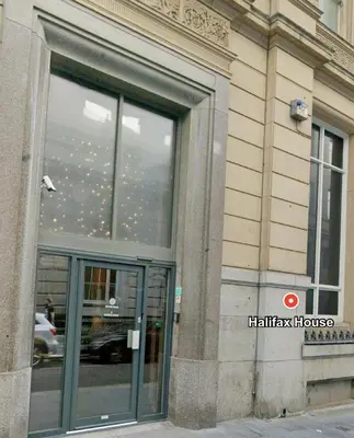a window of a building with a reflection of a car in it at 5 Halifax House Apartment 7 in Liverpool