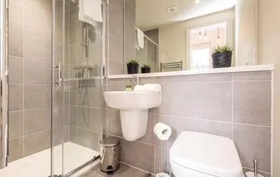 a bathroom with a toilet and a sink and a shower at 71 Townhouse By Elite in Liverpool