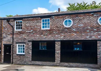 an old brick building with two garage doors at 91 Roscoe by Elite in Liverpool