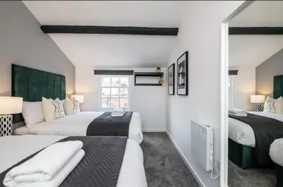 a bedroom with two beds and a mirror at 91 Roscoe by Elite in Liverpool