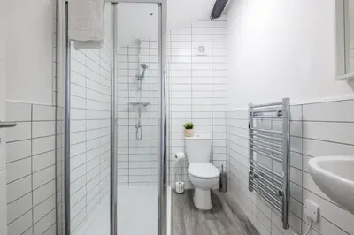 a white bathroom with a toilet and a sink at 91 Roscoe by Elite in Liverpool