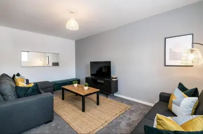 a living room with a couch and a table at 91 Roscoe by Elite in Liverpool
