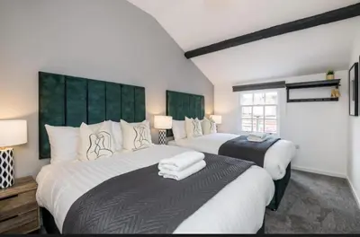 a bedroom with two beds and two lamps in it at 91 Roscoe by Elite in Liverpool