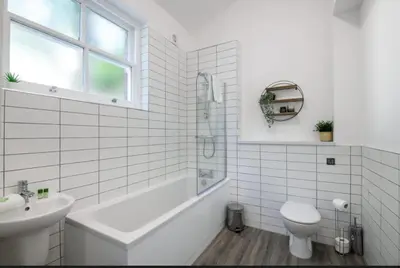 a bathroom with a tub and a toilet and a sink at 91 Roscoe by Elite in Liverpool