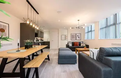 a living room with a couch and a table at The Coach House by Elite in Liverpool