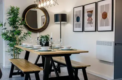 a dining room with a table and a mirror at The Coach House by Elite in Liverpool