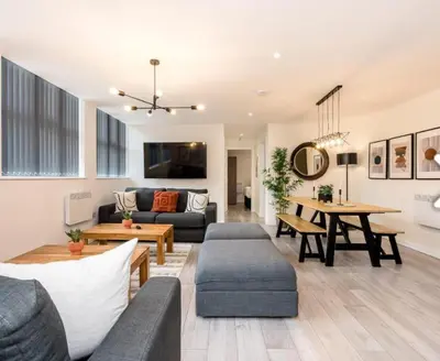 a living room with a couch and a table at The Coach House by Elite in Liverpool