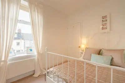 a white crib in a room with a window at Clitheroe Wilson Retreat. Central Lancashire in Clitheroe
