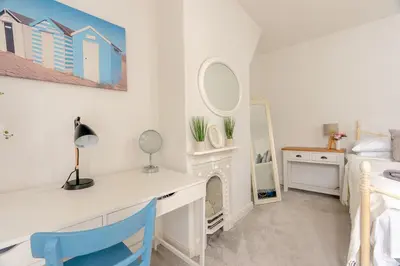 a bedroom with a desk and a bed and a mirror at Clitheroe Wilson Retreat. Central Lancashire in Clitheroe