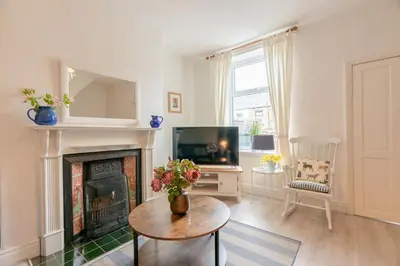 a living room with a fireplace and a tv at Clitheroe Wilson Retreat. Central Lancashire in Clitheroe