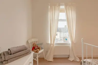 a childs bedroom with a crib and a window at Clitheroe Wilson Retreat. Central Lancashire in Clitheroe