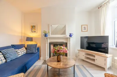 a living room with a blue couch and a tv at Clitheroe Wilson Retreat. Central Lancashire in Clitheroe