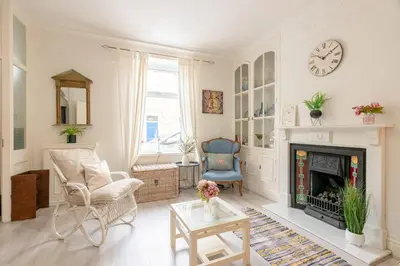 a living room with a fireplace and a clock on the wall at Clitheroe Wilson Retreat. Central Lancashire in Clitheroe