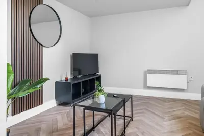 a living room with a black table and a mirror at St George's Quarter Stay - Modern City Centre Duplex - Perfect for Business & Leisure - FREE PARKING - WiFi Included - Close to transport links in Liverpool