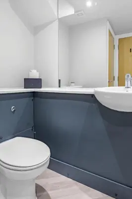 a bathroom with a white toilet and a sink at St George's Quarter Stay - Modern City Centre Duplex - Perfect for Business & Leisure - FREE PARKING - WiFi Included - Close to transport links in Liverpool