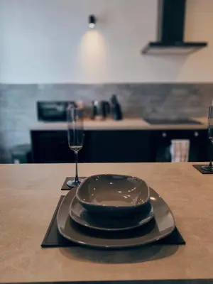 a plate and a glass of wine on a table at Ocean Breeze in Blackpool