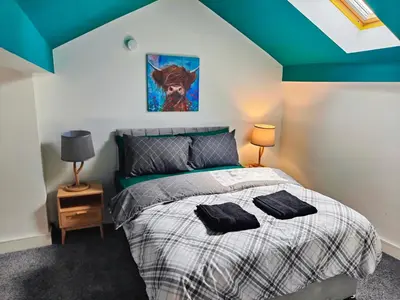 a bedroom with a bed with two pillows on it at Ocean Breeze in Blackpool