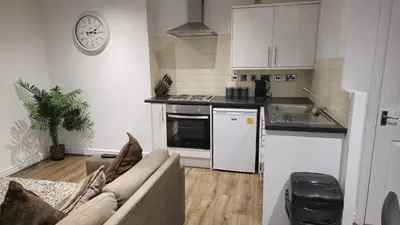 a living room with a couch and a kitchen at Irwell Chambers by L3 Apartments in Liverpool
