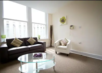 a living room with a couch and a table and a chair at Irwell Chambers by L3 Apartments in Liverpool