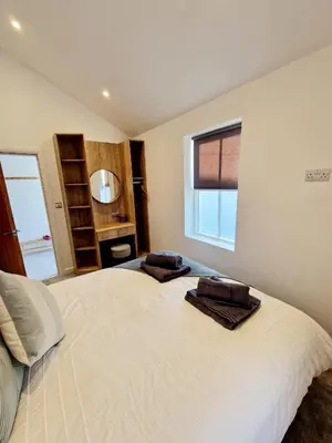 a bedroom with a bed with two towels on it at The Old Bakehouse in Ulverston